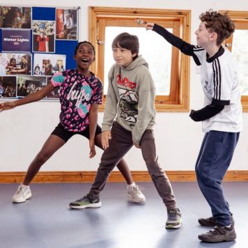 Three of our Youth Theatre members taking part in a session. Photo by Camilla Adams.
